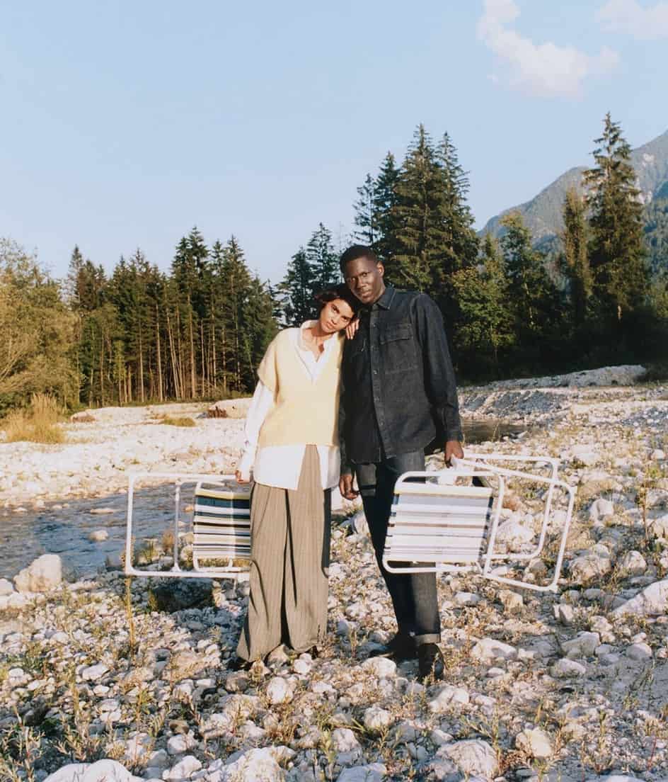 two people standing in a rocky riverbed