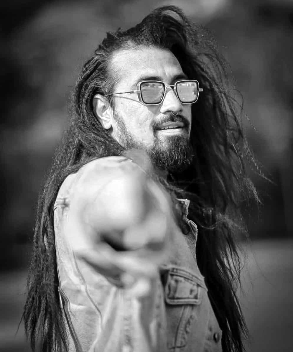 man in sunglasses with long braided hair