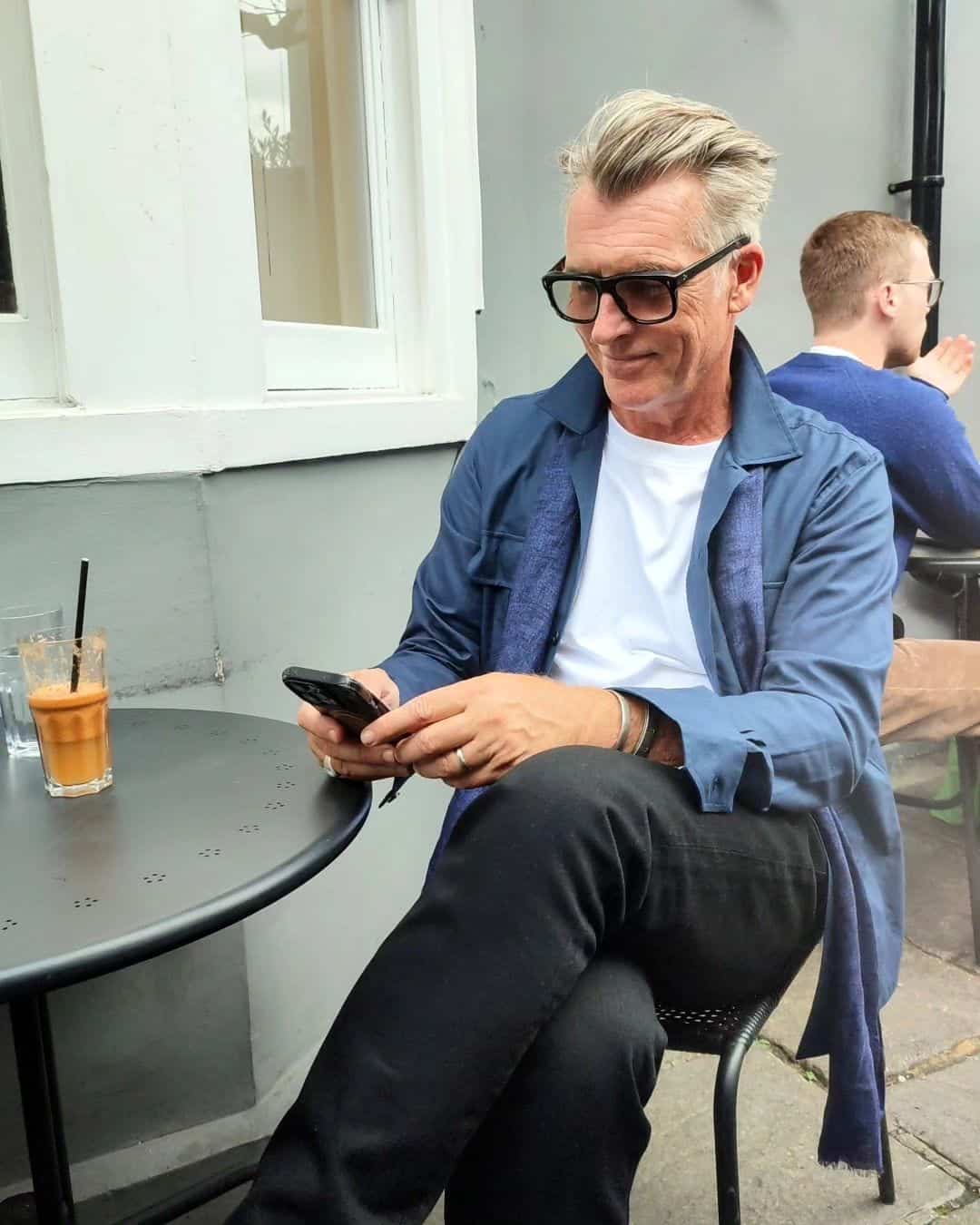 man smiling while checking his phone